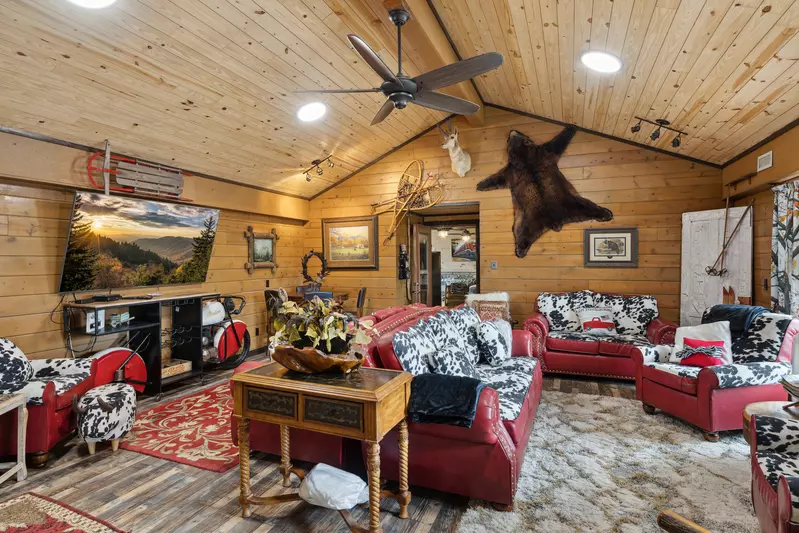 Great room — timber ceiling, stone fireplace